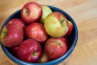 Fresh Red and Green Apples in a Blue Ceramic Bowl