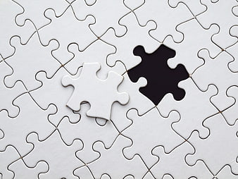 Missing white puzzle piece on blank jigsaw background