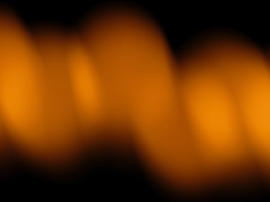 Abstract Blurred Orange Bokeh Lights on Black Background