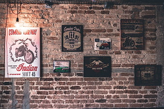 Vintage Motorcycle and Car Signs on Exposed Brick Wall
