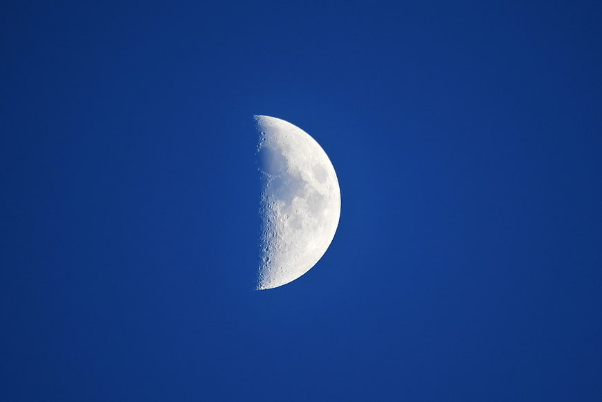 Half Moon Against Deep Blue Sky