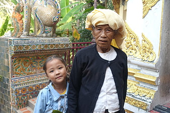 Senior Woman And Young Girl At Thai Temple