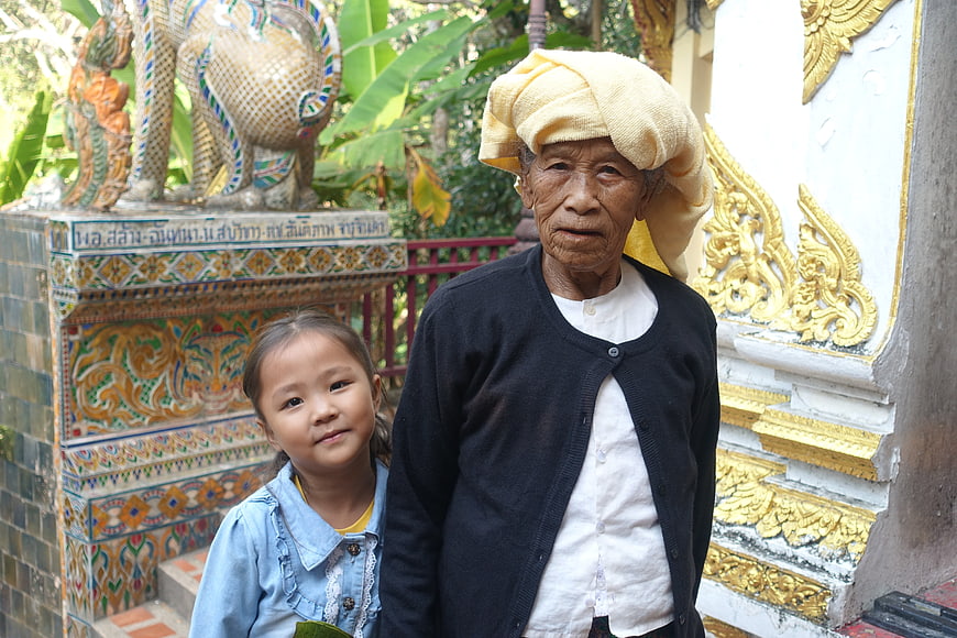 Senior Woman And Young Girl At Thai Temple
