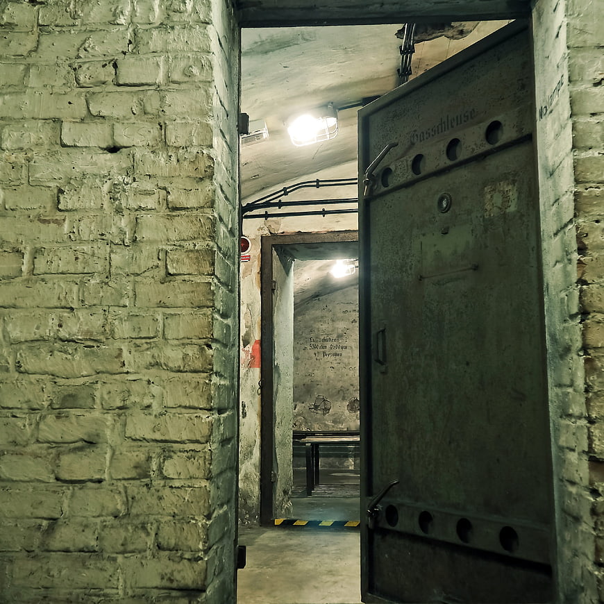 Historic WWII Bunker Interior With Heavy Metal Door And Brick Walls