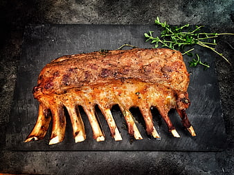 Roasted Lamb Rack on Dark Slate with Fresh Herbs
