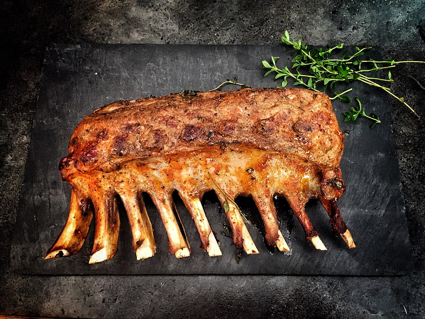 Roasted Lamb Rack on Dark Slate with Fresh Herbs