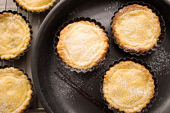 Freshly Baked Vanilla Custard Tarts on Black Plate