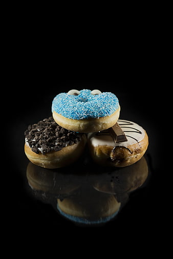 Stacked Gourmet Donuts with Blue Sprinkles and Chocolate Toppings