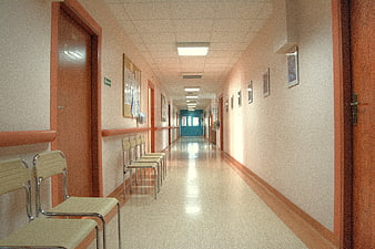 Empty Hospital Corridor With Waiting Chairs And Fluorescent Lighting