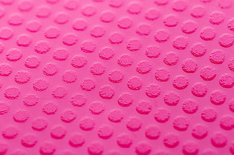 Pink Textured Surface with Raised Dots Pattern