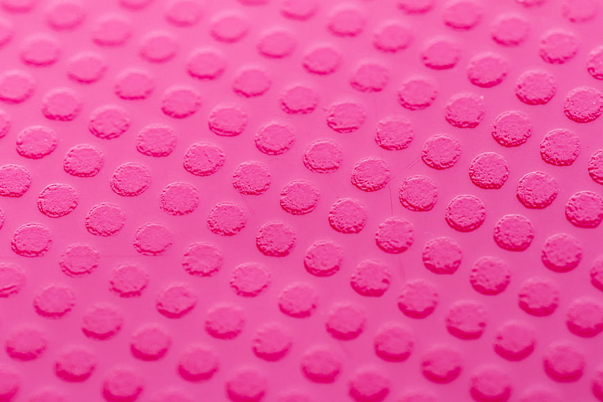 Pink Textured Surface with Raised Dots Pattern