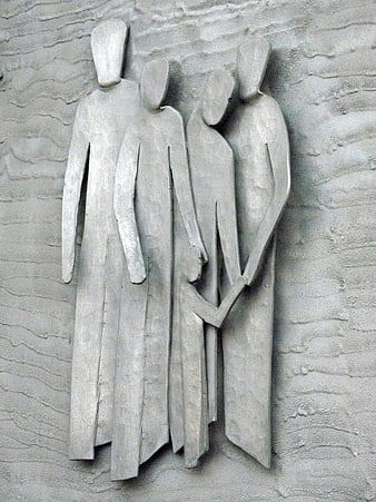Modern metal relief sculpture of four abstract figures