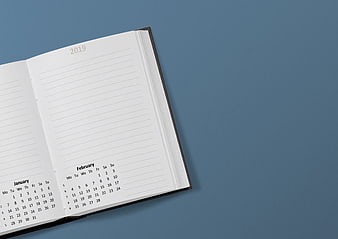 Open 2019 Planner Notebook With January And February Calendar On Blue Background