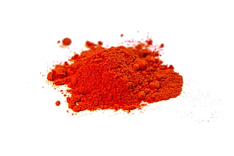 Pile of vibrant red paprika spice powder on white background