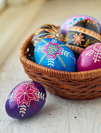 Colorful Hand-Painted Easter Eggs in Wicker Basket