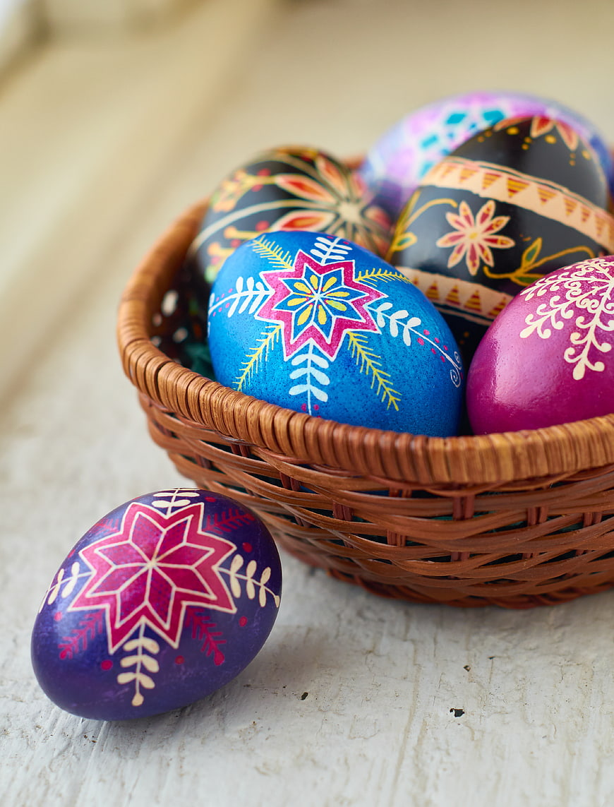 Colorful Hand-Painted Easter Eggs in Wicker Basket