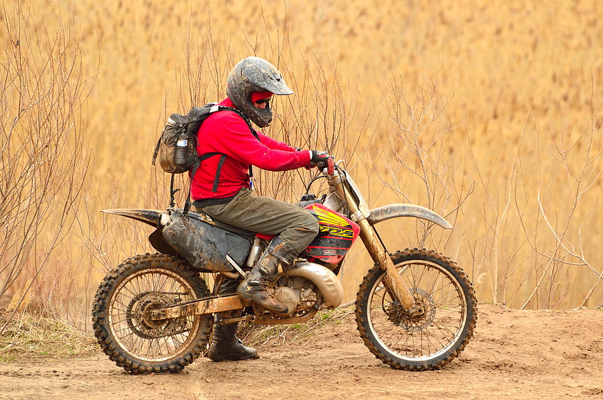 Motorcyclist in Red Jacket Riding Dirt Bike on Trail