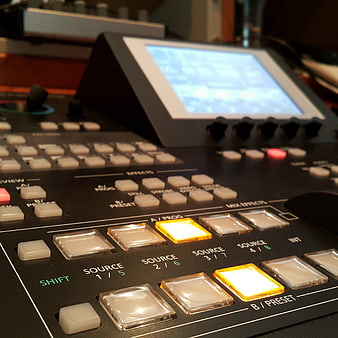 Close-up of professional video editing control surface with illuminated buttons