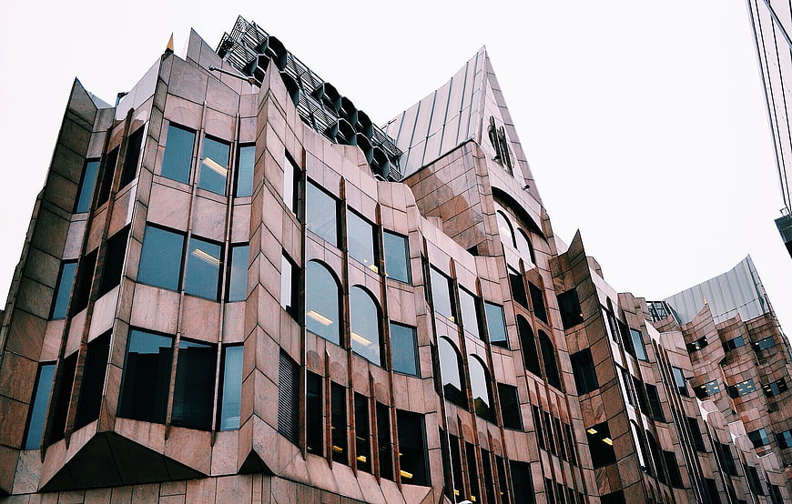 Low angle view of modern brown stone office building