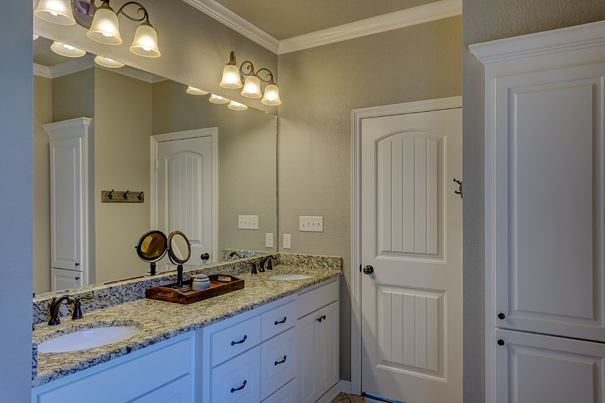Modern bathroom interior with double vanity and granite countertop