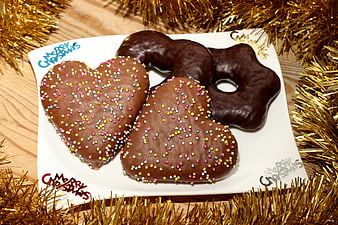 Chocolate Frosted Heart and Star Shaped Christmas Cookies on White Plate