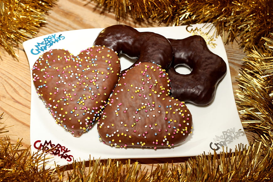 Chocolate Frosted Heart and Star Shaped Christmas Cookies on White Plate