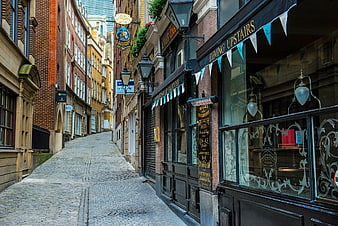Cobblestone Alley in London with Traditional Pub and Shops