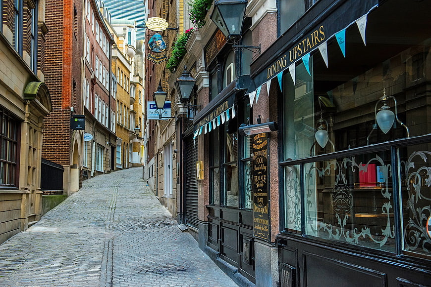 Cobblestone Alley in London with Traditional Pub and Shops