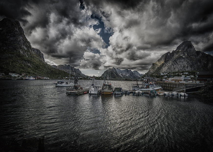Dramatic HDR Fishing Boats in Lofoten Harbor Under Stormy Sky