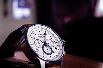 Close-up of white chronograph watch with leather strap