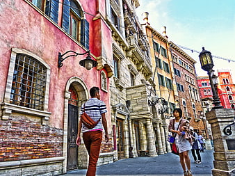 Tourists walking through colorful European-style architecture at Tokyo DisneySea