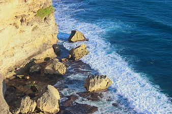 High Angle View of Ocean Waves Crashing Against Rocky Cliffs