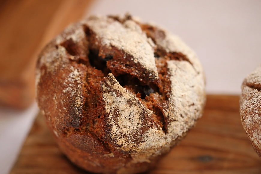 Close-up of rustic chocolate bread dusted with flour