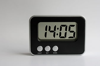 Modern Digital Alarm Clock Displaying 14:05 On White Background