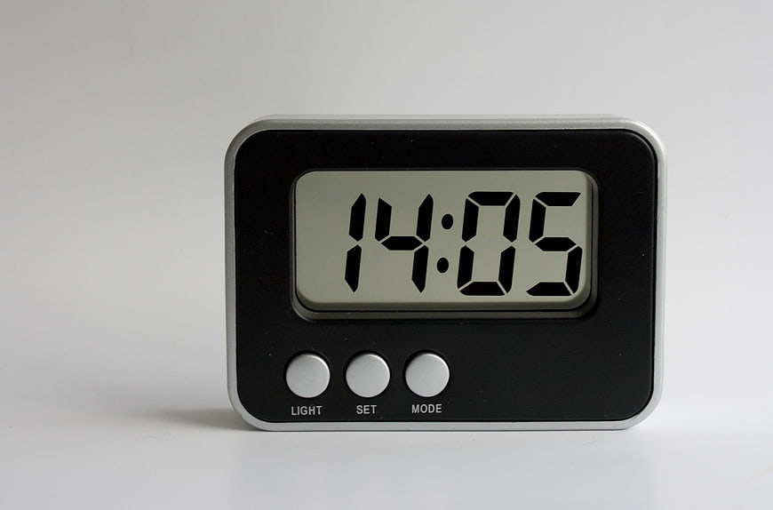 Modern Digital Alarm Clock Displaying 14:05 On White Background
