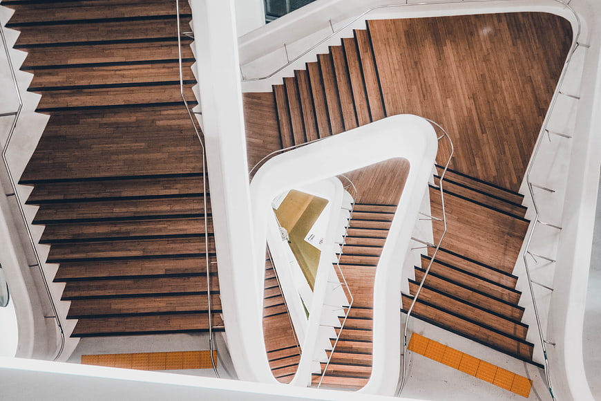 Modern spiral staircase with wooden steps and white curves