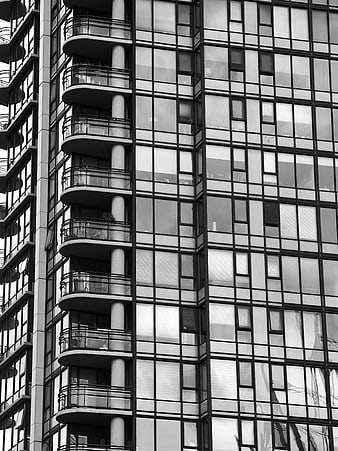 Black and white modern apartment building facade with balconies
