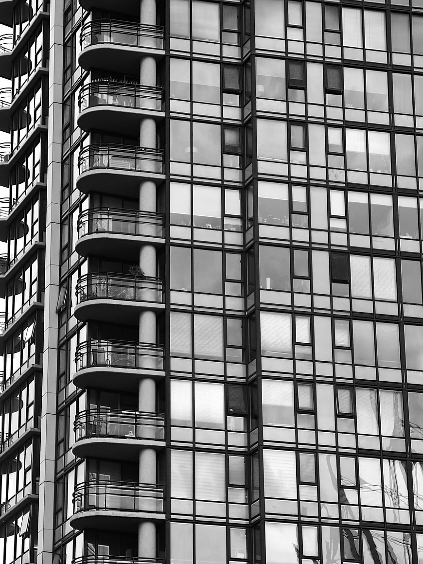 Black and white modern apartment building facade with balconies
