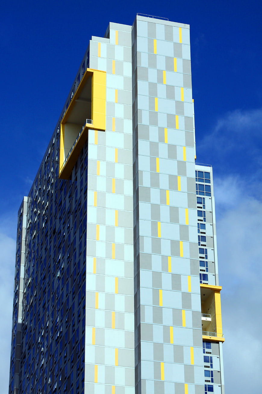 Modern High-Rise Building with Yellow and Gray Facade
