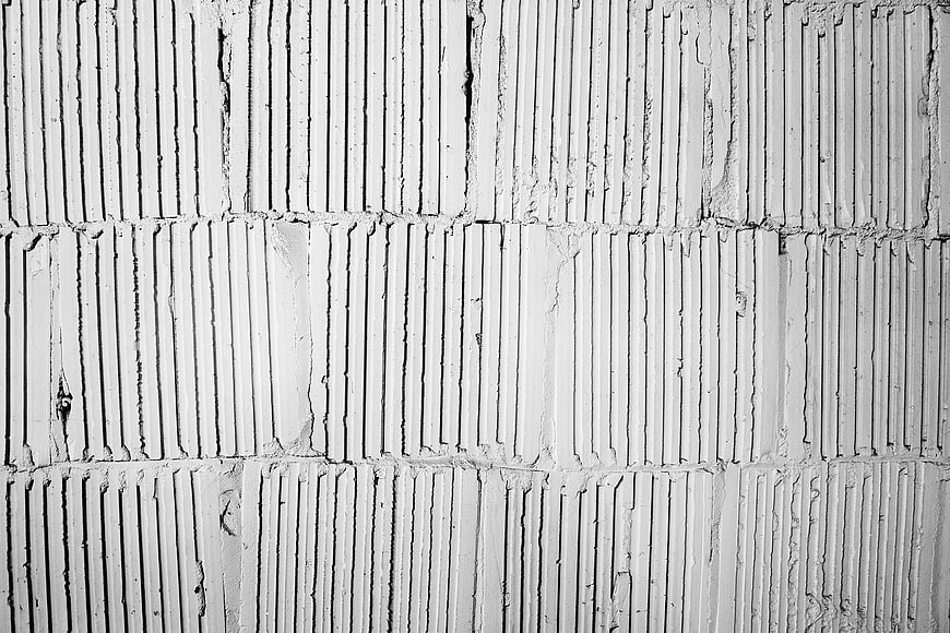 Black and white textured concrete wall pattern