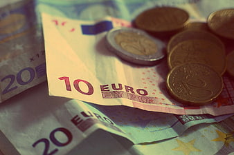 Close-up of Euro banknotes and coins with shallow depth of field