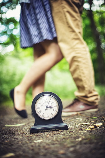 Vintage Clock on Ground with Couple Walking Away