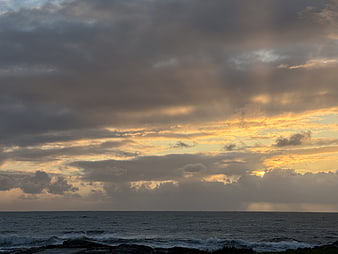 Dramatic Ocean Sunset With Golden Clouds And Breaking Waves