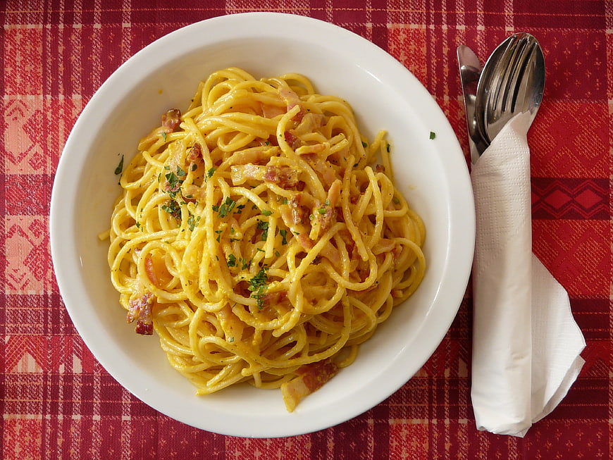 Top View of Spaghetti Carbonara on Red Plaid Tablecloth