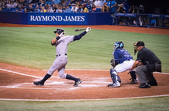 New York Yankees batter swinging at home plate during a baseball game