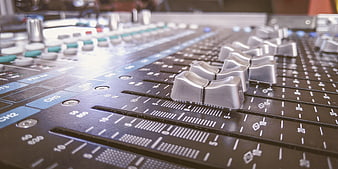 Close-up of professional audio mixing console sliders