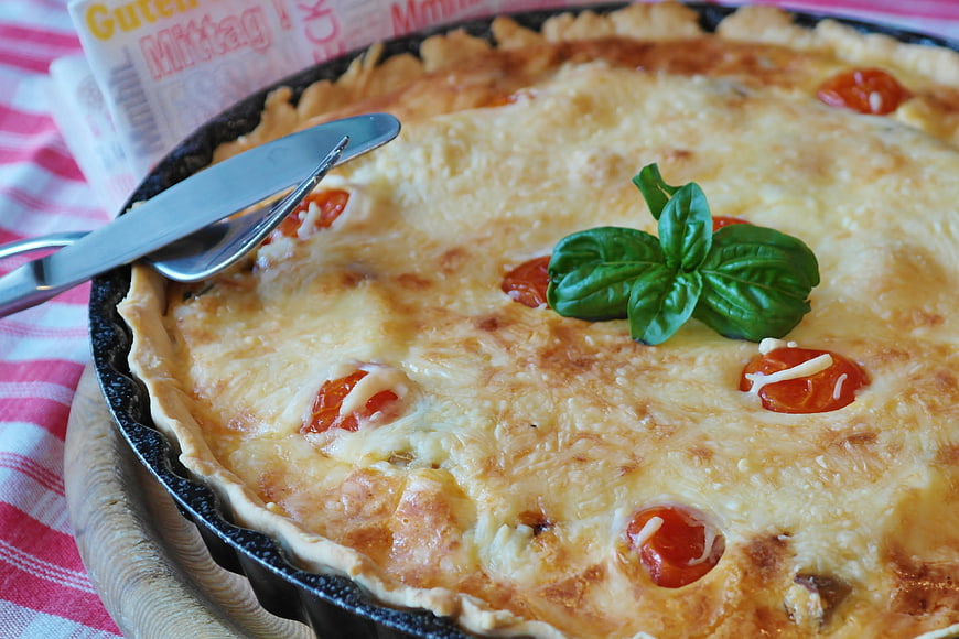 Fresh Quiche with Basil Garnish in Cast Iron Pan