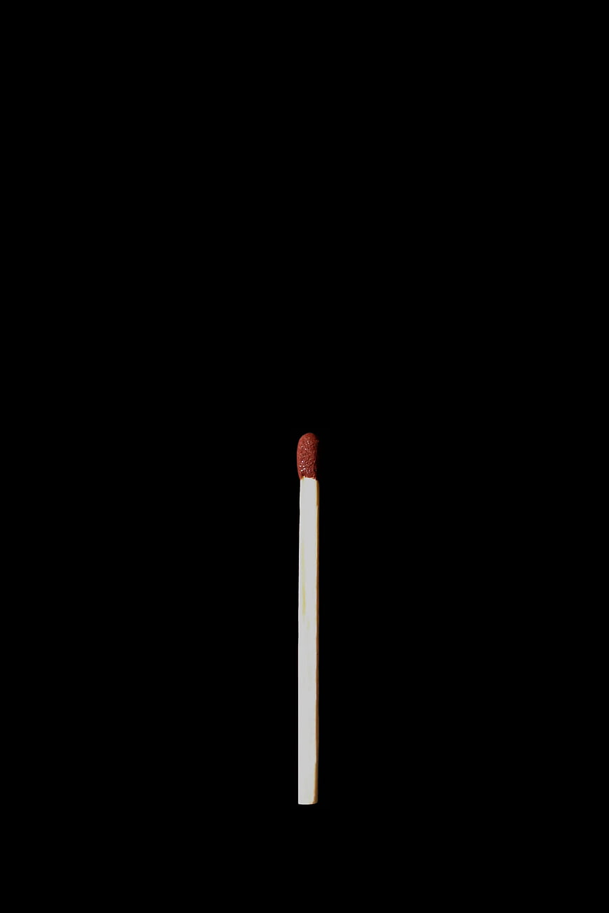 Single white matchstick on black background