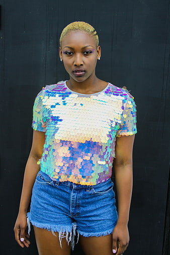 Woman in Rainbow Sequin Top and Denim Shorts