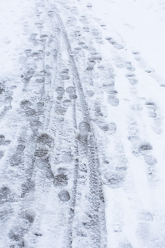 Footprints and tracks in fresh white snow texture